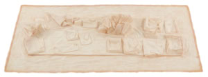 Tactile latex cast of a desk surface and objects by Herbert Stattler, capturing the physical traces, folds, and deformations of a workspace in a flexible, translucent material.